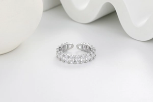 Detail shot of silver open ring featuring oval zircon stones in a classic prong setting