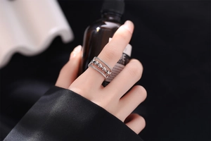 Detailed close-up of triple-layered silver anxiety ring with rotating sensory beads on a finger