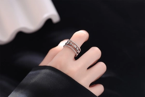 Detail of silver triple-layered spinning bead ring for anxiety relief on finger