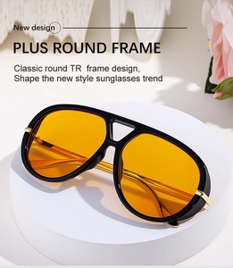 Close-up of retro aviator sunglasses with black TR frame and yellow lenses with gold accents
