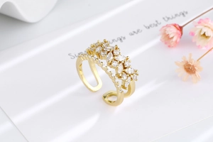 Detail of a gold double-layer open ring featuring marquise and round cut white zircons