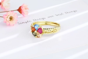 Macro detail of gold-plated open ring with five-color heart-shaped cubic zirconia stones
