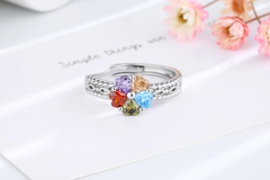 Macro shot of silver adjustable ring with five colorful heart-shaped cubic zirconia stones