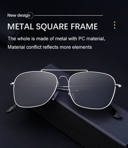 Detail view of silver square metal frame sunglasses on a black textured case
