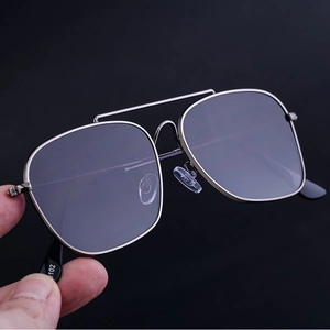 Macro detail of silver double bridge metal frame sunglasses with purple anti-reflective lenses