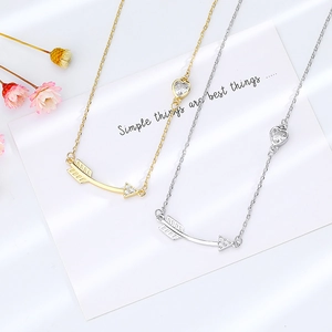 Minimalist heart and arrow pendant necklace with zircon crystals in gold and silver