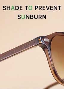 Détail de lunettes de soleil ambre foncé avec texture de branche quadrillée et accents argentés