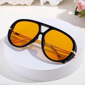 Retro pilot sunglasses with black frame, yellow lenses and gold metal accents