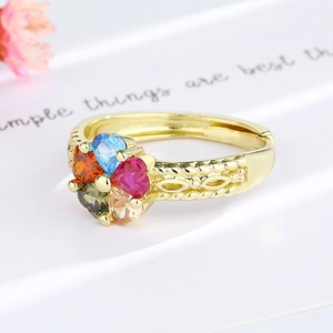Adjustable gold ring with colorful heart-shaped stones and intricate filigree details