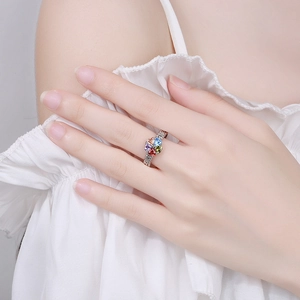 Fashionable flower ring with multi-colored heart-shaped gemstones on a textured silver band