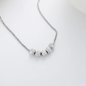 Elegant silver box chain necklace featuring five sandblasted stardust round beads