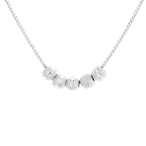 Minimalist silver bead necklace with five frosted and faceted charms on a box chain