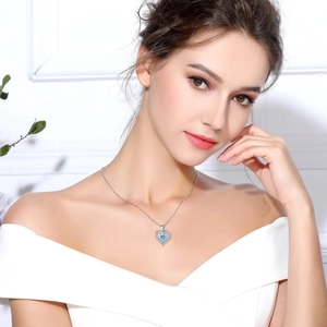 Elegant S925 silver heart necklace with blue zircon pendant worn by a female model