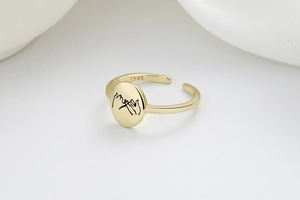 Macro shot of S925 silver ring featuring pinky swear engraving and adjustable gold band