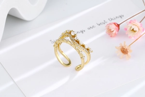 Detail of gold-plated multi-layer wave ring with shimmering zircon stones