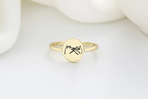 Macro detail of gold S925 sterling silver ring featuring a promise gesture engraving
