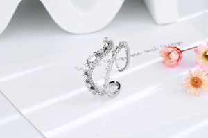 Detail view of double-layer wave ring with cubic zirconia stones and adjustable band