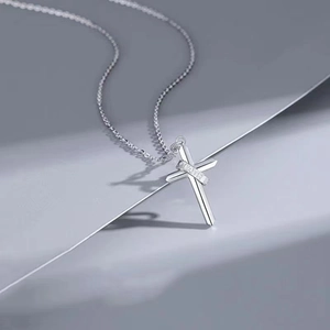 Minimalist silver cross necklace for men featuring FAITH engraving and sleek metal finish