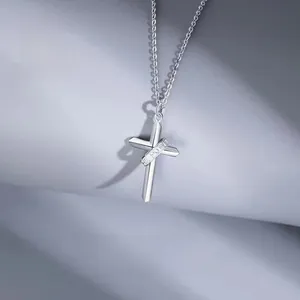 Detailed macro view of silver cross pendant with Faith is the power engraved ring band