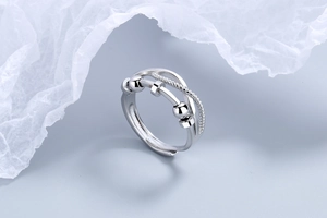Detail of silver spinner ring with rotating beads for anxiety relief and stress reduction