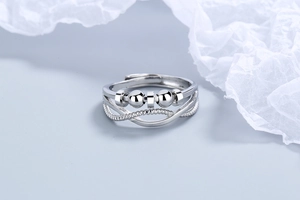 Detailed close-up of adjustable silver anti-stress ring with moving beads and twisted band