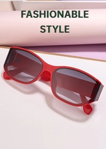 Detail of red oversized wrap-around sunglasses with grey lenses and fashionable frame