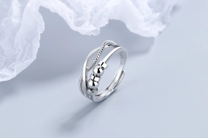 Detail of adjustable S925 silver fidget ring with three movable beads and layered bands