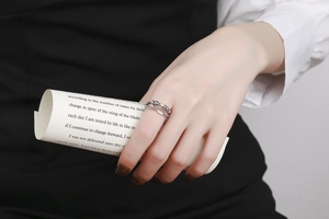 Detail of silver fidget ring with sliding beads on double bands worn by a model