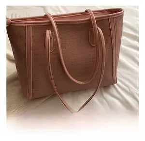 Détail du sac cabas rose avec texture tissée et poignée de transport confortable