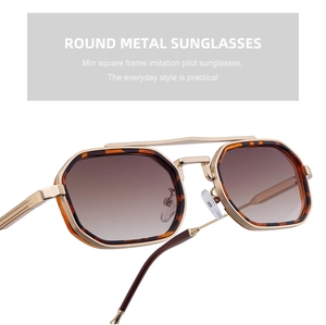 Détail de lunettes de soleil en métal doré avec décor écaille et double pont structuré