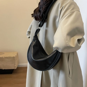 Minimalist black half-moon crossbody bag in premium textured leather for women