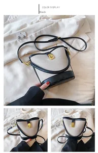 Detail view of contrast bucket bag with canvas texture, black leather trim and gold buckle