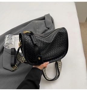 Detail of woven texture faux leather bag with gold hardware and two strap options