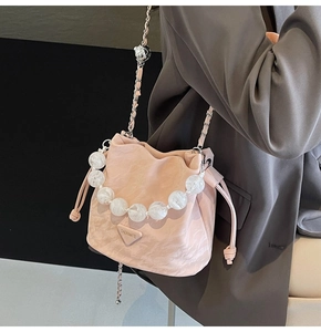 Détail du sac seau rose à cordon avec poignée en perles de marbre et bandoulière chaîne