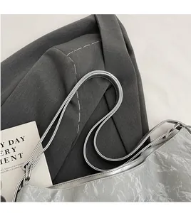 Detailed close-up of the silver wrinkled leather texture and seamless long shoulder strap