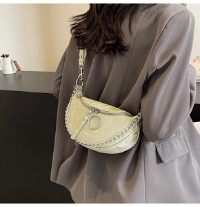 Detail of light green crescent bag with marble texture and silver chain strap