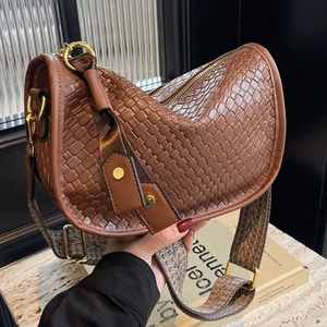 Brown woven texture hobo bag with a patterned wide strap and gold hardware