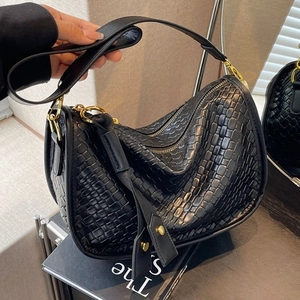 Retro black woven leather underarm bag with double zippers and gold metal buckles