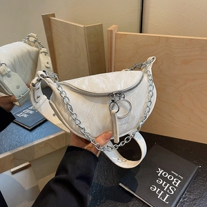 White marble texture crescent bag with silver chain strap shown in mirror reflection