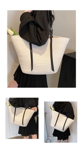Detail of off-white woven tote bag with black leather handles and large capacity