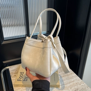 Sac seau blanc chic avec doubles poignées et large bandoulière en cuir texturé de qualité