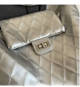 Detailed close-up of the silver quilted leather texture and square metal twist lock