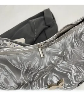Detail of smooth silver zipper and metallic ripple texture on a stylish travel backpack