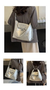 Detail view of the silver quilted tote showing versatile shoulder and backpack strap modes