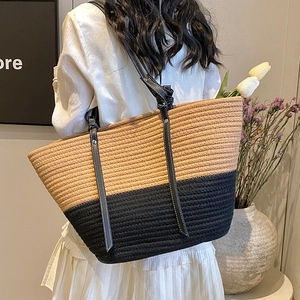 Fashionable large woven tote bag with contrast black and khaki panels and leather straps