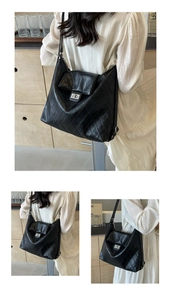 Detailed view of quilted black leather shoulder bag with silver turn-lock and spacious interior