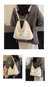Detail showing marble-textured off-white PU leather bag with silver butterfly buckle