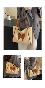 Detail of hand-woven straw tote bag with brown leather handles and butterfly patch