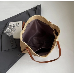 Internal view of a woven tote bag featuring brown fabric lining and a zip pocket