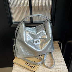 Silver quilted metallic shoulder bag with turn-lock closure and large capacity design